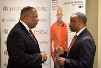 Industry, Investment, and Commerce Minister, Hon. Anthony Hylton (left), is engaged in discussion with Jamaica Promotions Corporation (JAMPRO) Chairman, Milton Samuda, prior to the start of Monday’s (June 15) Business Leaders Power Breakfast at Hilton Rose Hall Hotel in Montego Bay, St. James. The breakfast formed part of scheduled activities for the 6th Biennial Jamaica Diaspora Conference, being held from June 13 to 18, at the Montego Bay Convention, under the theme: ‘Jamaica and The Diaspora: Linking for Growth and Prosperity’.  
