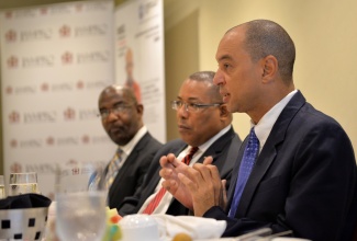 Industry, Investment, and Commerce Minister, Hon. Anthony Hylton (centre), and President, University College of the Caribbean (UCC), Dr. Winston Adams (left), listen to a presentation by GraceKennedy Limited Chief Executive Officer, Don Wehby, during Monday’s (June 15) Business Leaders Power Breakfast at Hilton Rose Hall Hotel in Montego Bay, St. James. The breakfast formed part of scheduled activities for the 6th Biennial Jamaica Diaspora Conference, being held from June 13 to 18, at the Montego Bay Convention, under the theme: ‘Jamaica and The Diaspora: Linking for Growth and Prosperity’.  
