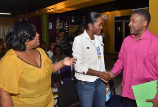 Minister with responsibility for Sport, Hon. Natalie Neita Headley (left), introduces Minister of Science, Technology, Energy and Mining, Hon. Phillip Paulwell (right) to Marketing Manager, Jamaica Beverages, Terry Ann Burrell, during the official launch of the ‘Joie De Vie’ Wellness Festival on Friday (January 3), at the National Housing Trust’s (NHT) Overtime Lounge in Kingston. The event is scheduled for February 1-2 at the Fort Clarence Beach in St. Catherine.