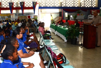 Minister of Water, Land, Environment and Climate Change, Hon. Robert Pickersgill (right), addresses students during the opening ceremony for Geographic Information System (GIS) Day 2013, held on November 20, in the Assembly Hall at the University of the West Indies, Mona campus. 