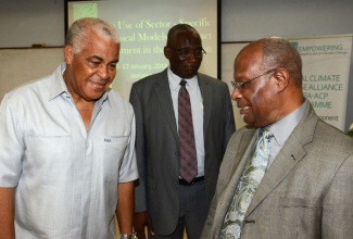 Minister of Water, Land, Environment and Climate Change, Hon. Robert Pickersgill (left), converses with Executive Director, Caribbean Community Climate Change Centre (CCCCC), Dr. Kenrick Leslie (right), following the opening ceremony of a regional training workshop on climate change on January 6, on the University of the West Indies’ (UWI) Mona campus. Looking on is Director of Climate Change in the Ministry, Albert Daley.