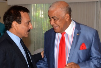 Minister of Water, Land, Environment and Climate Change, Hon. Robert Pickersgill (right), is conversing with  United Nations Resident Coordinator, Dr. Arun Kashyap, during a workshop for the 3rd National Communication and Biennial Update Report to the United Nations Framework Convention on Climate Change (UNFCC), held on Tuesday, October 14,  at the Terra Nova Hotel in Kingston.