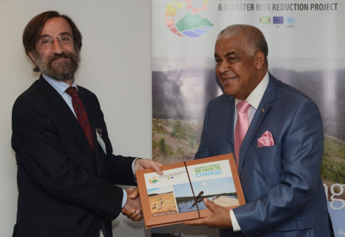 Minister of Water, Land, Environment and Climate Change, Hon. Robert Pickersgill (right), presents Head of Cooperation for the European Union (EU) Delegation in Jamaica, Jesús Orús Báguena, with a Climate Change Audio-Visual Tool Kit, during a ceremony at the Ministry’s New Kingston offices on May 28.  