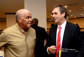 Minister of Water, Land, Environment and Climate Change, Hon. Robert Pickersgill (left), is in discussion with Ambassador of the Federal Republic of Germany, His Excellency, Josef Beck, at the opening of the Second Caribbean Workshop on the Nagoya Protocol on Access and Benefit Sharing (ABS) of genetic resources, held on Monday, November 25, at the Jamaica Pegasus Hotel, New Kingston.