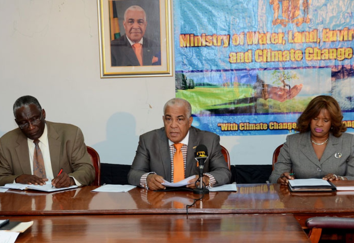 Water, Land, Environment and Climate Change Minister, Hon. Robert Pickersgill (centre), speaking at Tuesday’s (March 18) launch of the Climate Change Focal Point Network, at the Ministry’s New Kingston offices. Flanking him are: Principal Director of the Ministry’s Climate Change Division, Albert Daley (left), and Director General in the Ministry, Sharon Crooks.