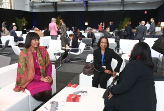 Prime Minister, the Most Hon. Portia Simpson Miller (left), is in light conversation with Jamaica's Ambassador to Belgium, Her Excellency Vilma McNeish (centre); and Minister with responsibility for Sport, Hon. Natalie Neita Headley, just before participating in a panel discussion on 'Women's Empowerment post-2015’ at the European Development Days forum in Brussels, Belgium on November 26.
