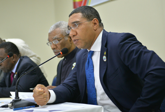 Prime Minister, the Most Hon. Andrew Holness (right), emphasises a point as he addresses the post CARICOM Press Conference on Thursday (July 6) in St. George's, Grenada. Others (from left) are: Prime Minister of Grenada, and incoming CARICOM chairman, Dr. The Hon. Keith Mitchell; and President of Guyana, and outgoing CARICOM chair, His Excellency David Granger.