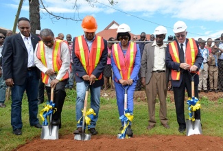 Prime Minister, the Most Hon. Portia Simpson Miller (3rd right), breaks ground for the $64 million expansion and rehabilitation of the Mandeville Primary and Junior High School in Central Manchester on Friday, November 27. Others (from left), are: Managing Director of the Jamaica Social Investment Fund (JSIF), Omar Sweeney; the School Board’s Chairman, Dr. Lloyd Quarrie; National Security Minister and Central Manchester Member of Parliament, Hon. Peter Bunting; Councillor for the Mandeville Division of the Manchester Parish Council, Jones Oliphant; and Education Minister, Hon. Rev. Ronald Thwaites. 