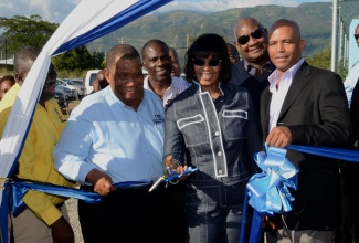 Prime Minister, the Most Hon. Portia Simpson Miller (centre), participates in the ribbon cutting exercise at the official commissioning of the Yallahs Irrigation System and launch of the Yallahs Agro Park in St. Thomas, on January 23. Also participating are (from left); Minister of Agriculture and Fisheries, Hon. Roger Clarke; President, Jamaica Agricultural Society, Senator Norman Grant;  Chairman, National Irrigation Commission (NIC), Dr. Conrad Douglas; and Member of Parliament, Western St. Thomas, James Robertson.