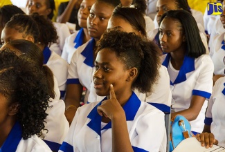 Nursing students at the Trench Town Polytechnic College, in St. Andrew, pay keen attention to address by Minister of Education, Youth and Information, Senator the Hon. Ruel Reid,  at a media launch of the College, on September 13. 