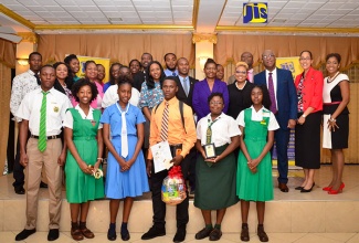 Awardees who submitted outstanding posters in Jamaica Information Service (JIS) Heritage Competition for 2017, share  a moment with executive members of the JIS and sponsors of the competition at Mona Visitors’ Lodge in St. Andrew on Monday, November 27. At second right (back row) is  Chief Executive Officer (CEO) of the JIS, Donna-Marie Rowe and at third right is Deputy CEO, Ian Boyne. 