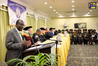 Education, Youth and Information Minister, Senator the Hon. Ruel Reid (left), addressing the audience at Western Carolina University's fall commencement, which was  held at the Knutsford Court Hotel in New Kingston on Friday, October 21.