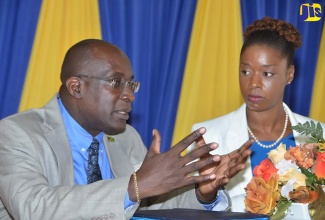 
Restorative Justice 1: Education, Youth and Information Minister, Senator the Hon. Ruel Reid (left), is in discussion with National Mathematics Coordinator at the Education Ministry, Dr.Tamika Benjamin. Occasion was a Mathematics and Literacy Education Forum for Board Chairpersons and Principals in regions five and six at the Kendal Conference Centre in Mandeville on October 25. 
