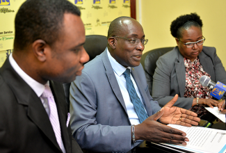 Minister of Education, Youth and Information, Senator  the Hon. Ruel Reid (centre), addresses a JIS Think Tank on August 28. He is flanked by Permanent Secretary in the Ministry, Dean-Roy Bernard; and Chief Education Officer, Dr. Grace McLean.