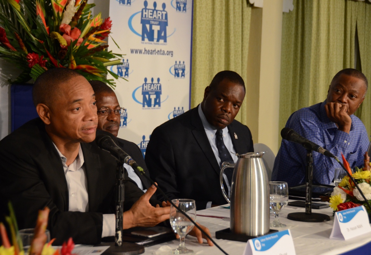 Chief Executive Officer of the Private Sector Organisation of Jamaica (PSOJ), Mr. Dennis Chung (left), responds to questions during a public forum at the Knutsford Court Hotel, which was  hosted as part of the HEART Trust/NTA Labour Market Research Day on February 16. Fellow panelists  (from second left)  are: Senior Specialist, Skills and Employability, International Labour Organisation (ILO), Dr. Hassan Ndahi; Executive Director of the HEART Trust/NTA, Dr. Wayne Wesley; and Head, Hugh Lawson Shearer Trade Union Education Institute, Mr. Danny Roberts.