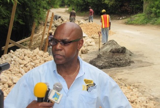 Chief Executive Officer of the National Works Agency (NWA), E.G. Hunter, provides an update on road projects being undertaken in Hanover, during a tour of the parish on Wednesday, July 27.