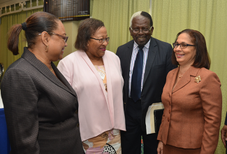 Minister of Labour and Social Security, Hon. Shahine Robinson (right), enjoys a light moment with Speaker of the House of Representatives, Hon. Pearnel Charles (second right); President of the Jamaica Confederation of Trade Unions, Helene Davis Whyte (left); and Chief Executive Officer of the Jamaica Employers’ Federation, Brenda Cuthbert. Occasion was the Workers’ Week Panel Discussion held at The Knutsford Court Hotel in New Kingston on Friday (May 19) under the theme ‘Preserving Workers’ Legacy through Health, Safety and Well-Being’.