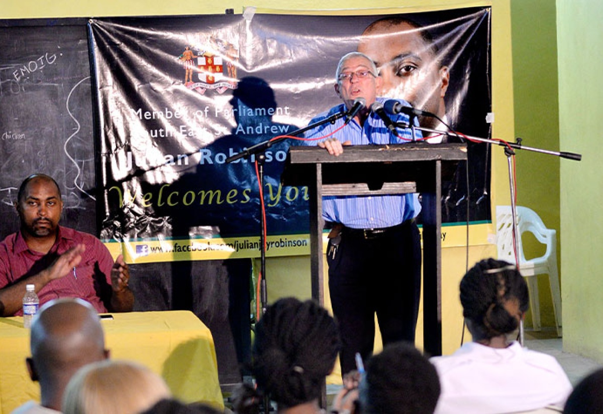 Minister of Education, Hon. Rev. Ronald Thwaites (at podium) addresses a forum on education held at the Christ Church in Vineyard Town on Tuesday (December 1). Pictured at the head table is State Minister for Science, Technology, Energy and Mining and Member of Parliament for South East St. Andrew, Hon, Julian Robinson. The event was organised by Mr. Robinson.