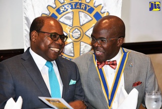 Minister of Tourism, Hon. Edmund Bartlett (left), shares a light moment with President of the Rotary Club of Kingston, Michael Buckle, during the weekly luncheon meeting of the club held on July 6 at The Jamaica Pegasus hotel.