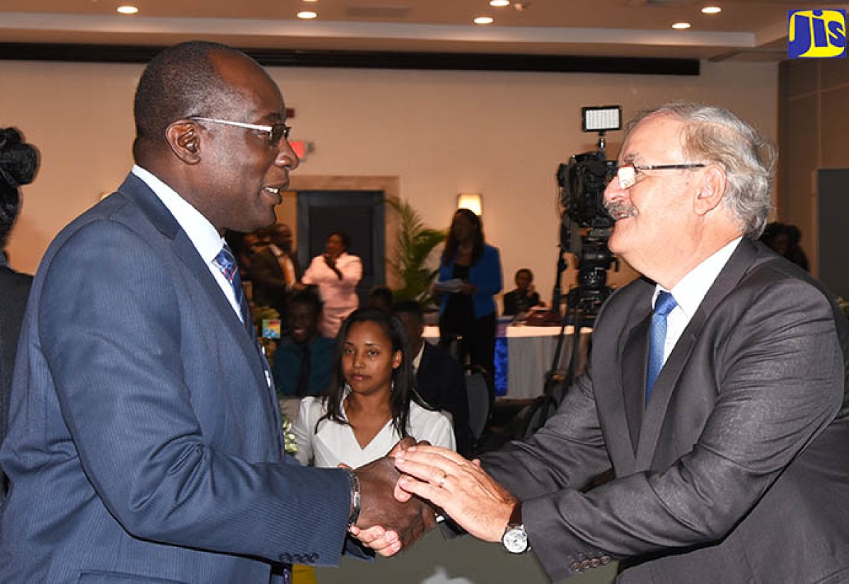 Minister of Education, Youth and Information, Senator the Hon. Ruel Reid (left), greets Chief Executive Officer, World Skills Americas, Professor Roberto Spada, during the Technical and Vocational Education and Training (TVET) Leaders’ Summit and Youth Forum held at The Jamaica Pegasus hotel in New Kingston on Tuesday (February 20). 