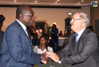 Minister of Education, Youth and Information, Senator the Hon. Ruel Reid (left), greets Chief Executive Officer, World Skills Americas, Professor Roberto Spada, during the Technical and Vocational Education and Training (TVET) Leaders’ Summit and Youth Forum held at The Jamaica Pegasus hotel in New Kingston on Tuesday (February 20). 