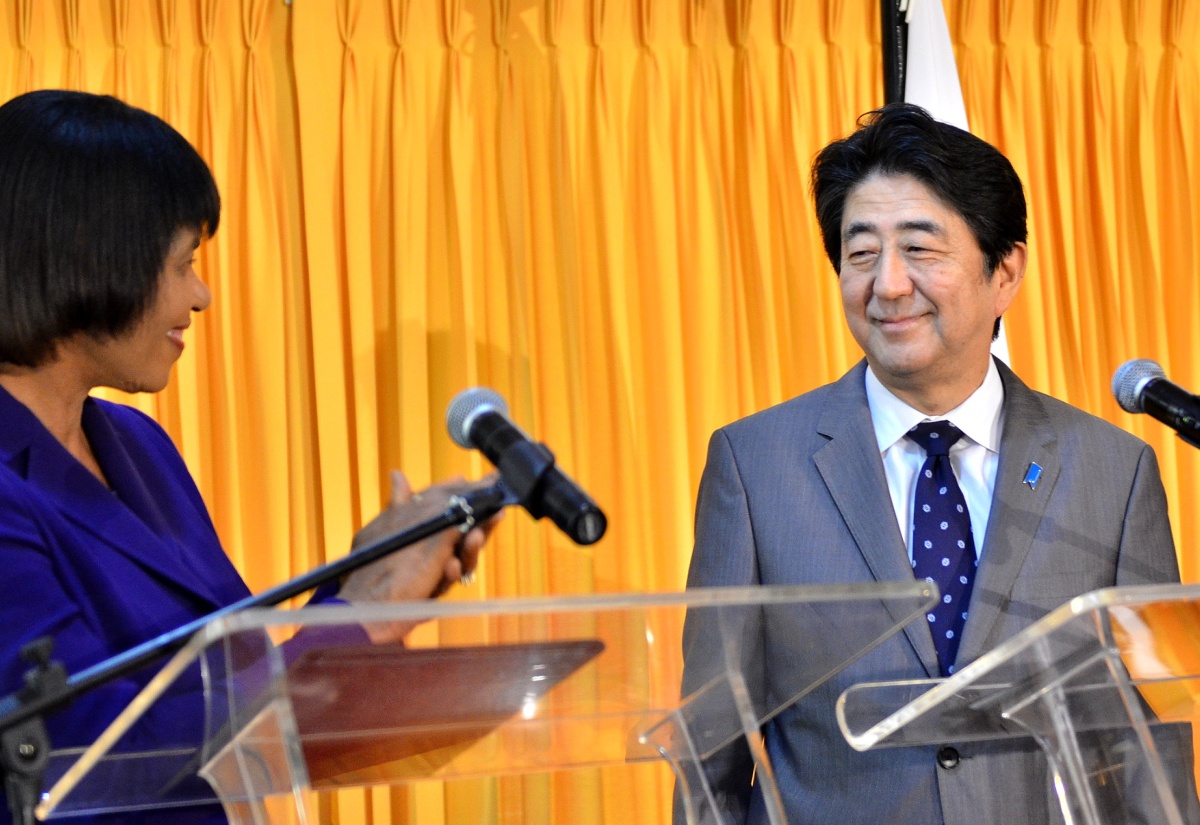 Prime Minister, the Most Hon Portia Simpson Miller, applauds the announcement of additional support to Jamaica by Prime Minister of Japan, His Excellency Mr. Shinzo Abe. Occasion was a joint presentation by the leaders after a bilateral meeting at Jamaica House on September 30. 