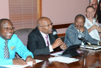 Minister without portfolio in the Ministry of Transport, Works and Housing, Hon. Dr. Morais Guy (second left), addresses the launch of the 5th Jamaica Driver and Traffic Safety Expo and the 2nd Road Safety 5K, at the Ministry’s offices in Kingston on May 15. Looking on (from left) are: Managing Director, Grennell’s Driving School and 5K/Expo Chairman, Alphonso Grennell; Chairman of Jamaica Promotions Corporation (JAMPRO) and Patron of the 5K/Expo, Milton Samuda; and Race car driver/ Chairman of Team Summerbell, David Summerbell.