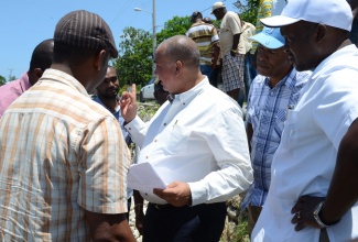 Minister of State in the Ministry of Transport, Works and Housing, Hon. Richard Azan (centre), is in discussion with National Works Agency (NWA) officials and political representatives in St. Elizabeth, during Thursday's (May 16) tour of the damaged Black River seawall in the parish. From left are: Member of Parliament for South West St. Elizabeth, Hugh Buchanan; Director for Regional Implementation and Special Projects at the NWA, Varden Downer; Mayor of Black River, Councillor Everton Fisher; and Councillor for the Siloah Division, Audie Myers.