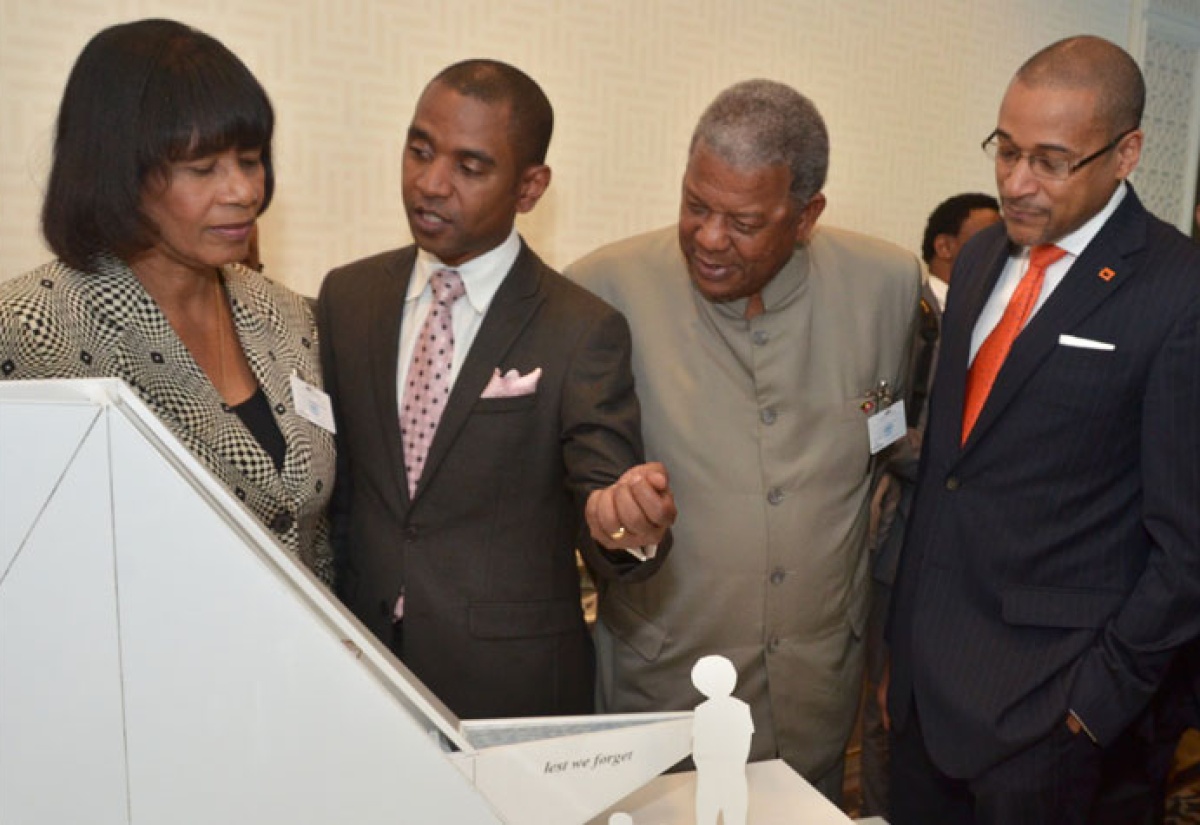 Mr. Rodney Leon (second left), winner of the design competition, ‘The Ark of Return’,  to be erected as a Permanent Memorial to the victims of slavery and the transatlantic slave trade at the United Nations (UN) Headquarters in New York,  explains his concept to (from left), Prime Minister, the Most Hon. Portia Simpson Miller; Antiguan Prime Minister, Hon. Baldwin Spencer and Jamaica's Permanent Representative to the United Nations, Ambassador Courtenay Rattray, at on September 23 unveiling at the UN. (FILE)
 