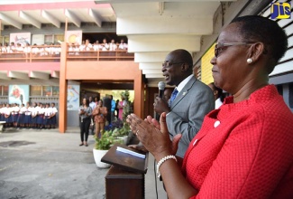 Minister of Education, Youth and Information, Senator the Hon. Ruel Reid (2nd right), addresses students at the Half-Way Tree Primary School in Kingston during a visit to the institution on Monday (September 4). At right is Principal of the School, Carol O’Connor Clarke. The Minister also visited the Old Harbour High and Old Harbour Primary schools in St. Catherine, and the New Day Primary and Junior High in Kingston.