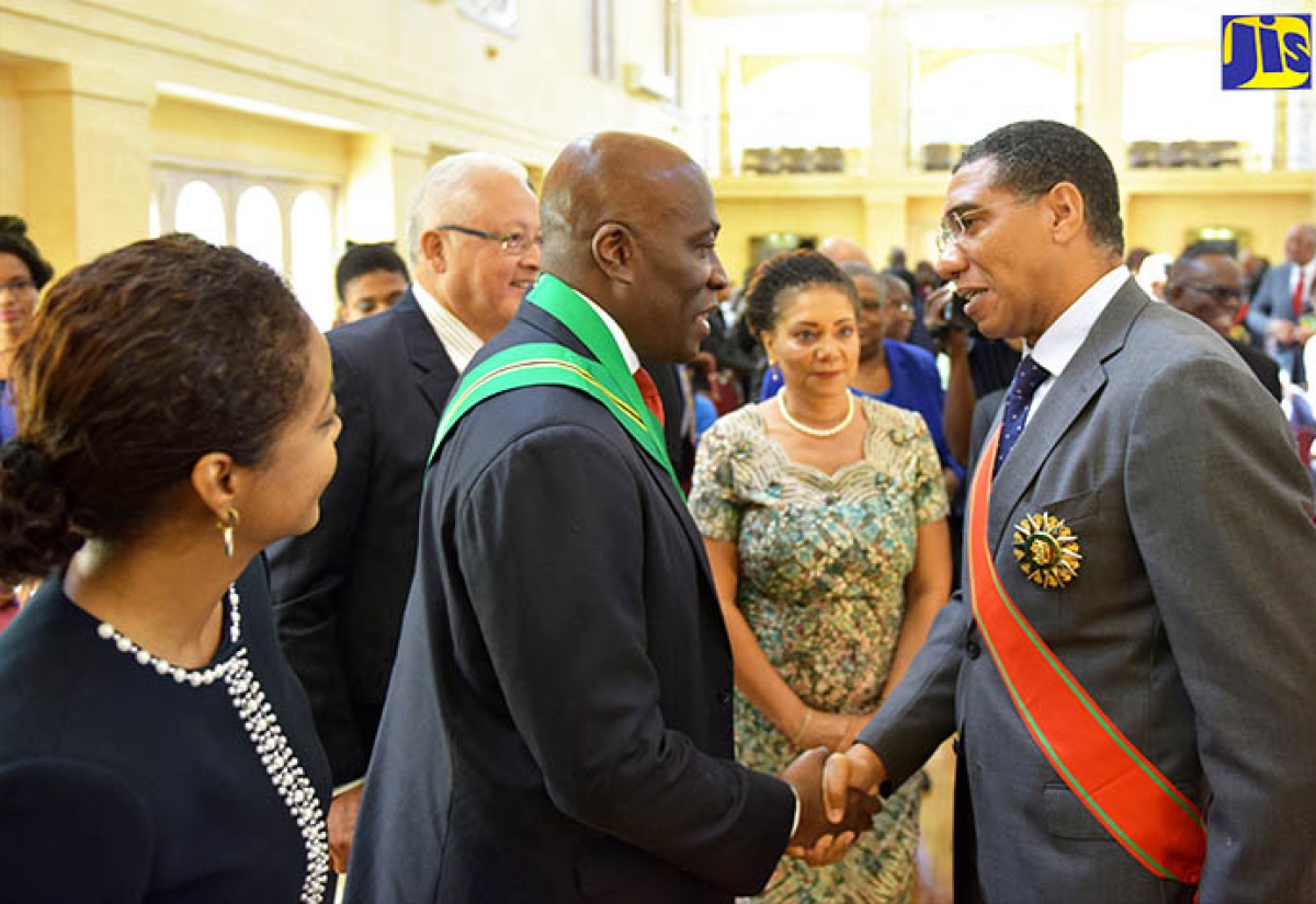 Prime Minister, the Most Hon. Andrew Holness (right), congratulates newly appointed Chief Justice, Bryan Sykes (second left), after he was sworn in at King’s House on Thursday (March 1). Looking on (from left) are Attorney General, Hon. Marlene Malahoo Forte; Justice Minister, Dr. Delroy Chuck; and the Chief Justice’s wife, Dr. Annette Crawford-Sykes.