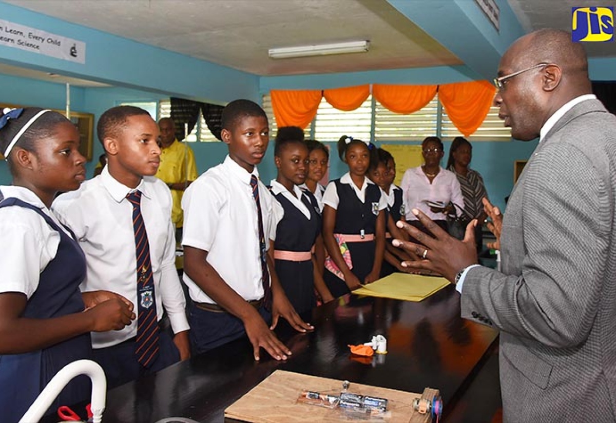 Education, Youth and Information Minister, Senator the Hon. Ruel Reid (right), addresses students of St. Mary Technical High School in Richmond, St. Mary, after touring the institution’s chemistry laboratory, which was renovated at a cost of approximately $1.8 million by State oil refinery, Petrojam. The school was one of several in St. Mary comprising the Ministry’s Region Two that were visited by Senator Reid as part of a tour of institutions to mark the start of the 2017/18 academic year.