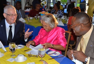 Minister of Education, Hon. Rev. Ronald Thwaites (left), shares a light moment with Chairman of the Barita Education Foundation, Rita Humphries-Lewin (centre), and Executive Director of the HEART/NTA, Dr. Wayne Wesley. Occasion was a breakfast forum to mark the 10th anniversary of the Barita Education Foundation, held on October 14, at the Terra Nova Hotel, St. Andrew.