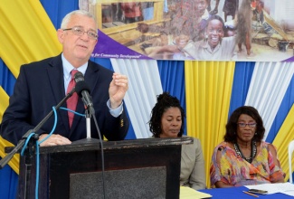 Minister of Education, Hon. Rev. Ronald Thwaites, emphasizes a point, while addressing a handing over ceremony for rehabilitation works at the St. Michael’s Infant School in Central Kingston, on December 5. Listening are (from left): Acting Principal of the school, Deverlyn Wilks-Kennedy and Managing Director, Jamaica Social Investment Fund (JSIF), Scarlette Gillings.