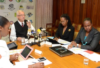 Minister of Education Hon. Rev. Ronald Thwaites (second left), emphasizes a point while outlining details of the 2013 Caribbean Secondary Education Certificate (CSEC) examination results, during a press briefing at the Ministry’s National Heroes Circle offices in Kingston on Monday (August 12). Listening keenly, from left, are Ministry officials: National Mathematic Coordinator, Dr. Tamika Benjamin; Permanent Secretary, Elaine Foster Allen; and Chief Education Officer, Grace McLean.