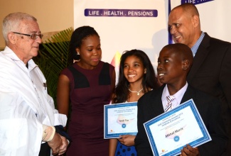 Education Minister, Hon. Rev. Ronald Thwaites (left), congratulates Guardian Life Limited’s top  Grade Six Achievement Test (GSAT) scholarship awardees Mikhail Morris (right) and Yendi Foo (centre). Occasion was the company’s 10th annual GSAT awards ceremony held on August 12 at the Jamaica Pegasus Hotel in New Kingston. Sharing the moment are President of Guardian Life Limited, Eric Hosin; and Youth Advocate, Kemesha Kelly. 