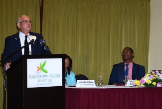 Minister of Education, Hon. Rev. Ronald Thwaites, addresses members of the Diplomatic Corps at the Knutsford Court Hotel in St. Andrew today (February 11).  Also pictured (from right), is State Minister for Foreign Affairs and Foreign Trade, Hon. Arnaldo Brown; and Inter-Secretary, Bilateral and Regional Affairs, Foreign Affairs Ministry, Ambassador Joy Wheeler. The session was held as part of activities to mark the 17th  annual staging of Diplomatic Week.