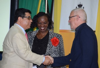 Minister of Education, Hon. Rev. Ronald Thwaites (right), greets Mexican Ambassador to Jamaica, His Excellency Gerardo Lozan (left), during the foreign languages annual general meeting today (Sept. 27), at the Ministry’s Caenwood Centre Auditorium in Kingston. Looking on is Modern Language Education Officer in the Ministry, Martha Corbett-Baugh.
