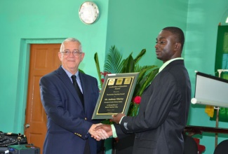 Minister of Education, Hon. Rev. Ronald Thwaites (left), presents Principal of the Lethe Primary School, Anthony Murray, with the Citation for the Leadership in Education Award, during a ceremony held at the school in Lethe, St. James, on November 29. The ceremony was held to honour the principal who has won the Award for his distinguished service in education.