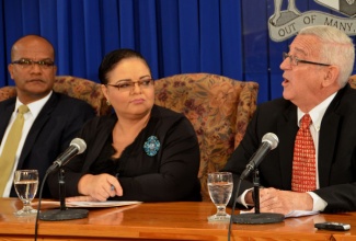 Minister of Education, Rev. Hon. Ronald Thwaites (right), responds to a question at a Jamaica House press briefing at the Office of the Prime Minister on Thursday, January 23, where he elaborated on  the findings of the Jamaica Constabulary Force (JCF) report. At left is National Security Minister, Hon. Peter Bunting; and Minister of Information, Senator the Hon. Sandrea Falconer (centre), who hosted the briefing.
