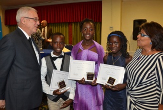 Minister of Education, Hon. Rev. Thwaites (left) speaks with Opposition Spokesperson on Education, Marissa Dalrymple Philibert (right), while looking on (from 2nd right) are three students from the constituency of South St. Andrew who were awarded the Detective Inspector Delvin ‘Sarge’ Grant Memorial scholarship valued at $250,000 each:  Felicia West, Nandi Richards, and Shamar Stewart. The awards function was held at the Knutsford Court Hotel on August 21.