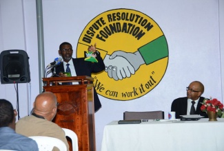 Chief Executive Officer, Dispute Resolution Foundation (DRF), Paul Hines, addresses stakeholders at the School Suspension Intervention Programme (SSIP) Tracer Survey Consultation, held at the DRF’s headquarters in Kingston, on October 30.
