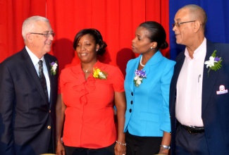 Minister of Education, Hon. Rev. Ronald Thwaites (left), speaks with (from second left) teacher at the Young Women’s Christian Association, Karlene Wilks; teacher at the Christiana Leased Primary School, Tracy-Ann McGhie-Sinclair; and Executive Chairman at Carlong Publishers (Caribbean) Limited, Carl Carby.  Occasion was the company’s annual Teachers’ Appreciation Luncheon held on Thursday, November 28, at the Jamaica Pegasus Hotel in Kingston. Mrs. McGhie-Sinclair and Ms. Wilks were two of 70 teachers being honoured for excellence in the profession.