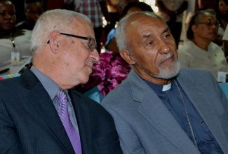 Education Minister, Hon. Rev. Ronald Thwaites (left), has a quick word with Archbishop Emeritus, Rev. Donald James Reece, at the opening session of the St. Joseph’s Teachers’ College’s inaugural Research Day on October 3.
