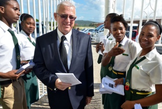 Education Minister, Hon. Rev. Ronald Thwaites is greeted by student ushers at Vere Technical High School where he attended the school's annual prize giving ceremony at the institution’s campus in Hayes, Clarendon, on Thursday, November 21.