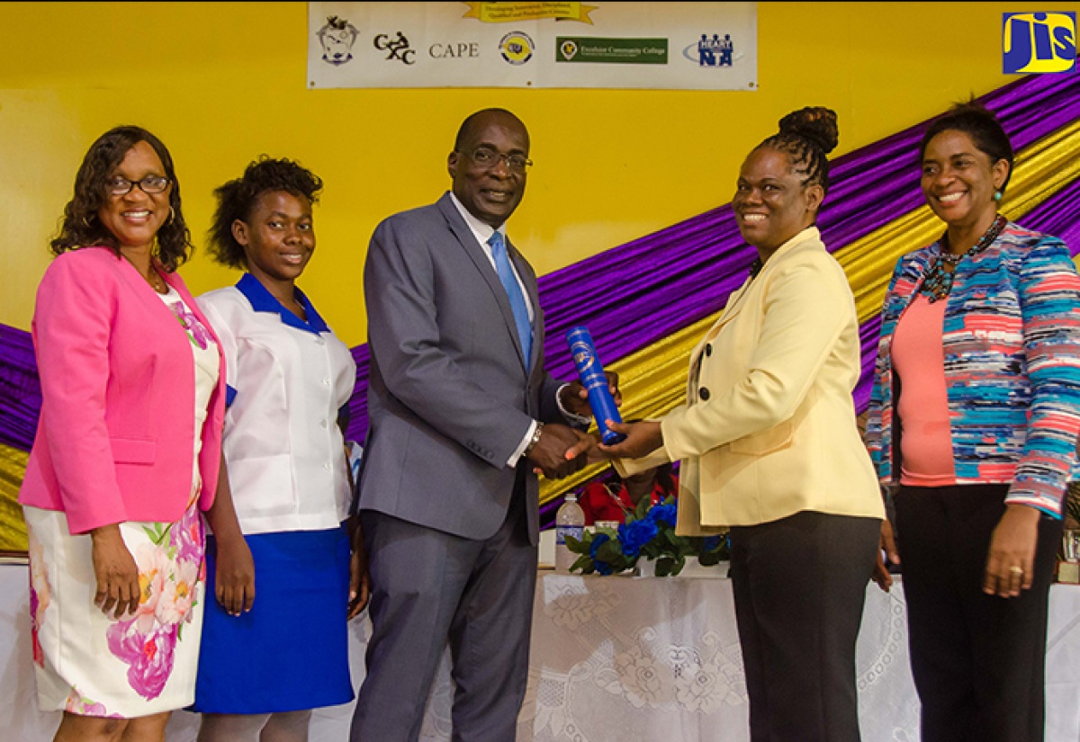 Minister of Education, Youth and Information, Senator the Hon. Ruel Reid (third left), receives the document for the Trench Town Polytechnic College to offer Council of Community Colleges of Jamaica (CCCJ)-certified courses from  Executive Director, CCCJ, Dr. Donna Powell-Wilson (second right) at the recent media launch of the St. Andrew-based institution. Others (from left) are Chairman of the college, Dr. Joan Spencer-Ernandez; nursing student, Shanique Rumble; and Principal of the college, Dr. Dosseth Edwards-Watson.