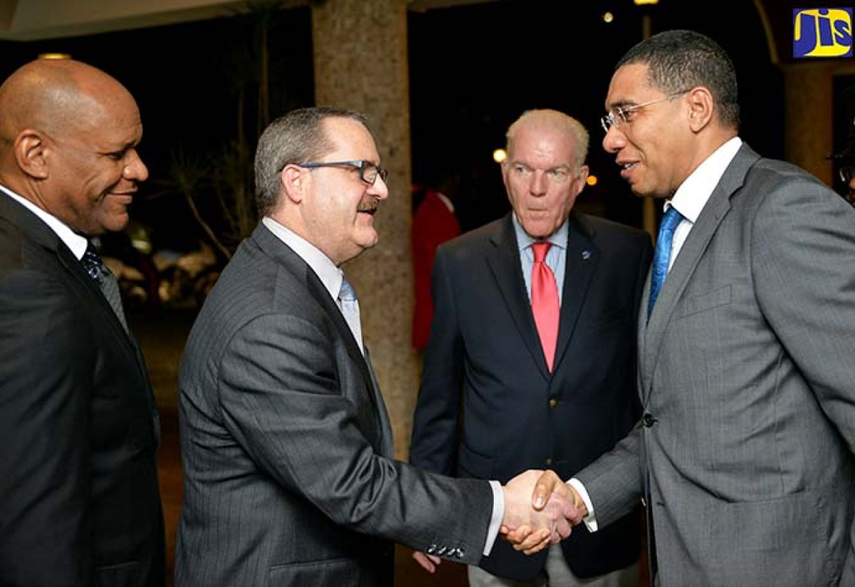 Prime Minister, the Most Hon. Andrew Holness (right), greets Managing Director of the United States-based investment and securities firm, Jefferies LLC, Gregory Fisher (2nd left), on arrival at The Jamaica Pegasus hotel in New Kingston on Tuesday (January 24), for the opening ceremony for the 12th Jamaica Stock Exchange (JSE) Regional Investments and Capital Markets Conference. Looking on (from left) are: JSE Chairman, Ian McNaughton; and The Jamaica Pegasus General Manager, Peter Hilary.