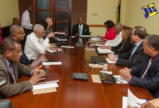 Minister of Tourism, Hon. Edmund Bartlett (head of table), addresses the inaugural meeting of the Tourism Competitiveness Taskforce at the Ministry’s New Kingston offices on June 23. The Taskforce forms part of the Ministry’s drive to reposition tourism to generate higher growth rates in both visitor arrivals and earnings. 