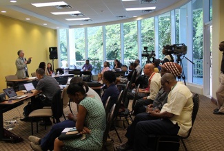 Head of Communications for the Intergovernmental Panel on Climate Change (IPCC), Jonathan Lynn, addresses a group of journalists and communication specialists from across the region, at a climate change media workshop, held on November 29 at the University of West Indies Regional Headquarters at Mona. 
