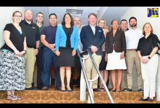 Labour and Social Security Minister, Hon. Shahine Robinson (5th left) and Permanent Secretary in the Ministry, Collette Roberts Risden (4th right), with United States employers who are in the island recruiting Jamaicans for the hotel sector in that country. The Minister hosted the employers at breakfast at the Hilton Rose Hall resort in Montego Bay, St. James, on  January 17.